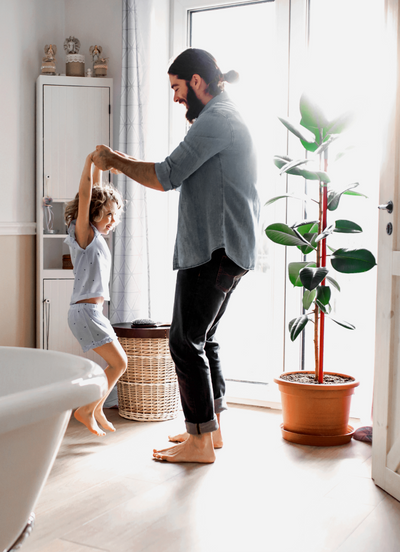 Dad and daughter playing and having fun in the bathroom